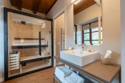 a bathroom with a sink and a shower at Hotel Cittadellarte in Biella