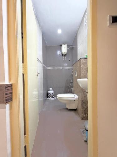 a bathroom with a toilet and a sink at Malaysia inn in Chennai