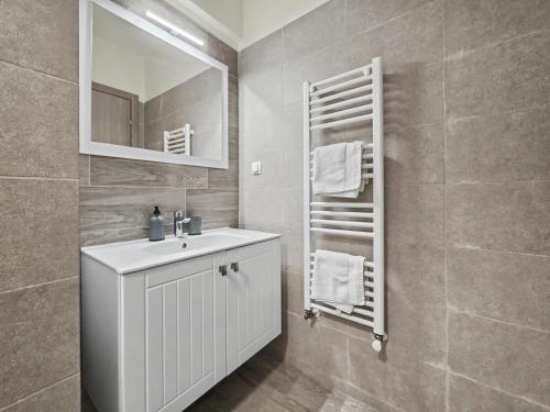 a bathroom with a white sink and a mirror at Konstanzer 103 - 2 Room Ap & Parking- Iulius Mal - Smart TV - Highspeed Wi-Fi in Iaşi