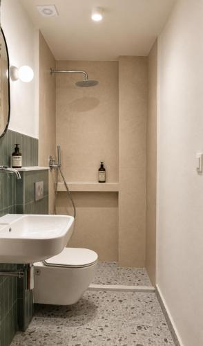 a bathroom with a white toilet and a sink at House No 10 in Olympic Beach