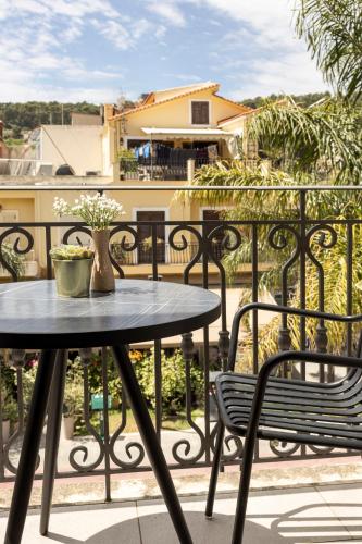 a table and two chairs on a balcony at KANTADA central suite in Argostoli