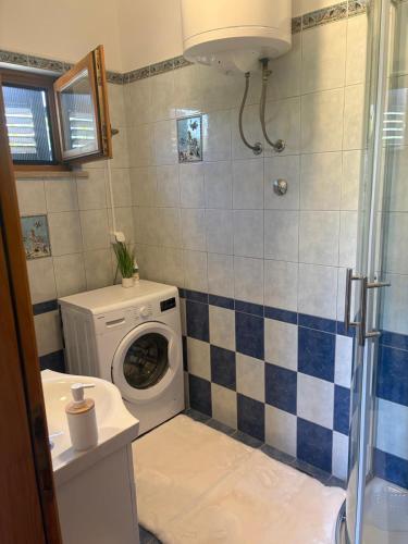 a bathroom with a washing machine and a washer at Apartment A1 Peroj in Peroj