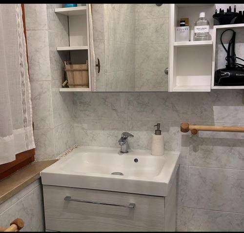 a bathroom with a white sink and a mirror at daNilomare in Marcelli