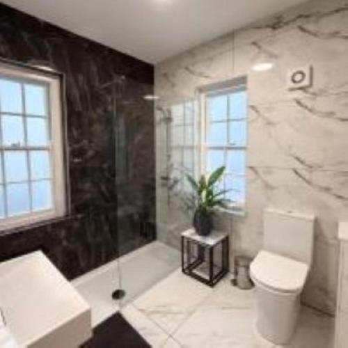 a bathroom with a tub and a toilet and a shower at Hilston Gate House in Skenfrith