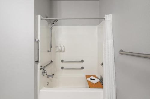 a shower in a bathroom with a shower curtain at Tombstone Grand Hotel, a Baymont by Wyndham in Tombstone