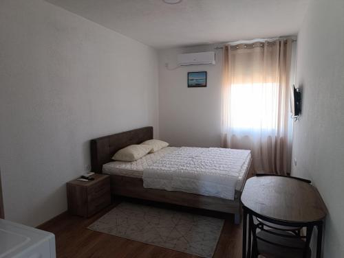 a small bedroom with a bed and a window at Prenociste Gradiska in Bosanska Gradiška