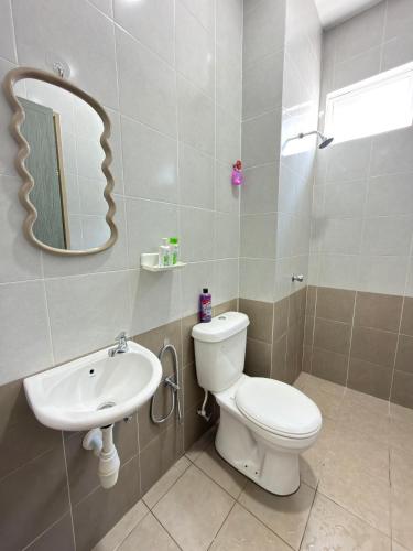 a bathroom with a toilet and a sink at Deandra Homestay- WiFi-Aircond-Dryer in Sungai Petani
