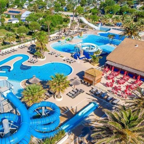 an aerial view of a resort with a water park at Mobilhome, Camping Le Marisol in Torreilles
