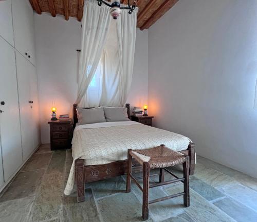 a bedroom with a large bed and a window at Kimoliatiko in Kimolos