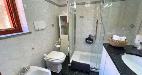 a bathroom with a toilet and a shower and a sink at The Light House - Olbia centro in Olbia