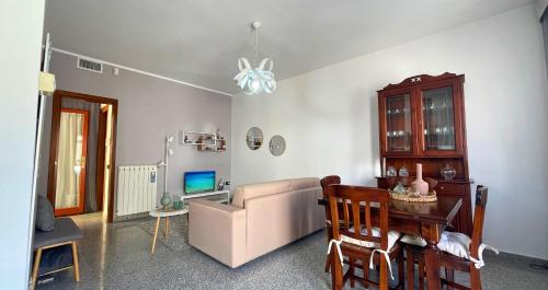 a living room with a couch and a table and a chair at The Light House - Olbia centro in Olbia