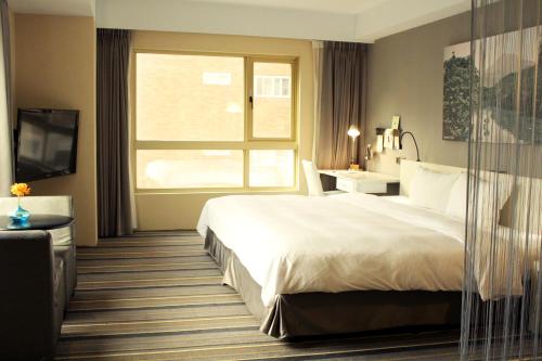 Hotelday Tamsuiにあるベッド