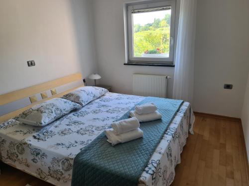 a bedroom with a bed with two towels on it at Alloro in Ankaran