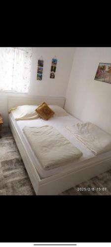 a white bed in a bedroom with at Mostar kuca pored jezera in Mostar