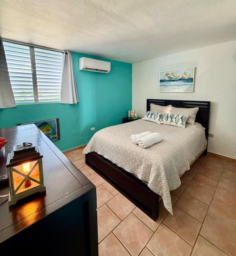 a bedroom with a bed in a room with blue walls at Sea View Rooftop in Cabo Rojo