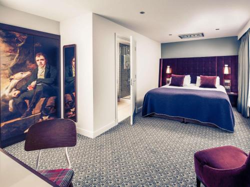 a hotel room with a bed and a painting at Mercure Inverness Hotel in Inverness