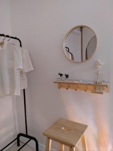 a bathroom with a mirror and a wooden stool at The Greenery Omok in Seoul