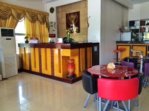 a dining room with a table and some chairs at Cindy Kelly Hotel in Olongapo