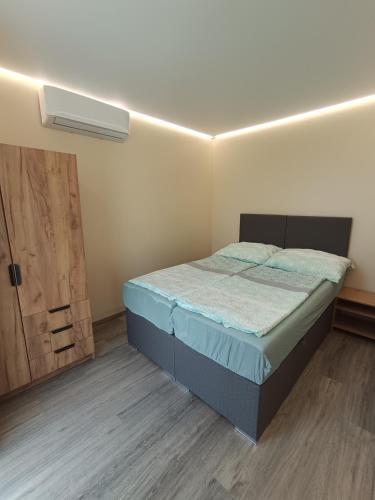 a small bedroom with a bed and a door at Bianka & Blanka in Poľný Kesov