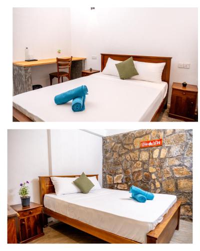 a bedroom with two beds with a blue pillow on it at Villa Whispering Leaves Kandy in Galaha Town