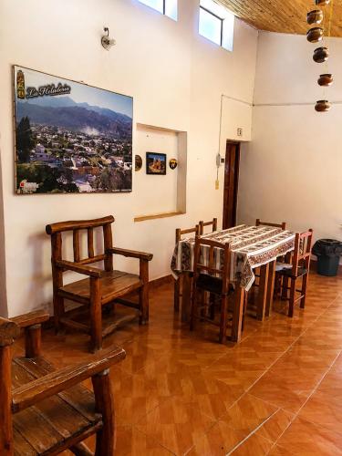 a dining room with a table and chairs at Posada Yacoraite Tilcara in Tilcara