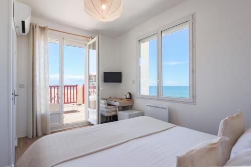 En eller flere senge i et værelse på Hôtel de La Plage