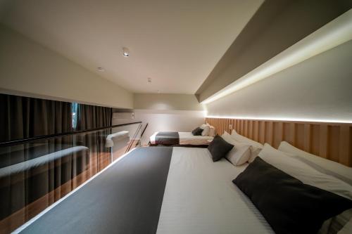 a large room with two beds and a bed sqor at Spa & Pool - Studio Apartments 365 in Tirana