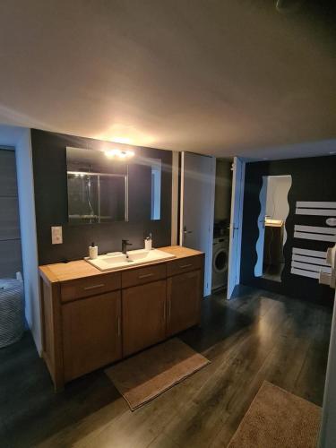a bathroom with a sink and a mirror at Le refuge médiéval - Appartement climatisé perché sous les toits de Billom in Billom