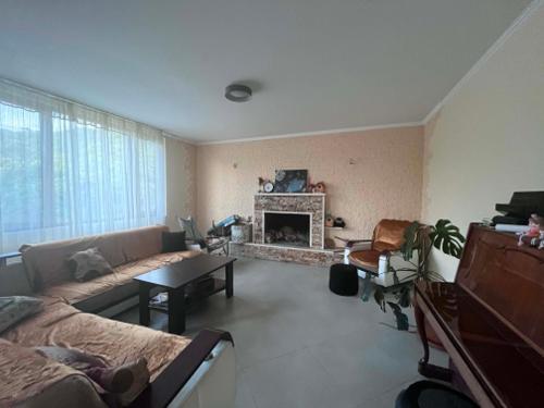 a living room with a couch and a fireplace at Likhauri Guesthouse in Likhauri