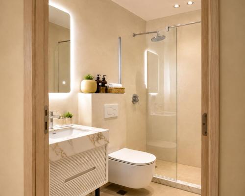 a bathroom with a shower and a toilet and a sink at OKEJ Hotel in Golem