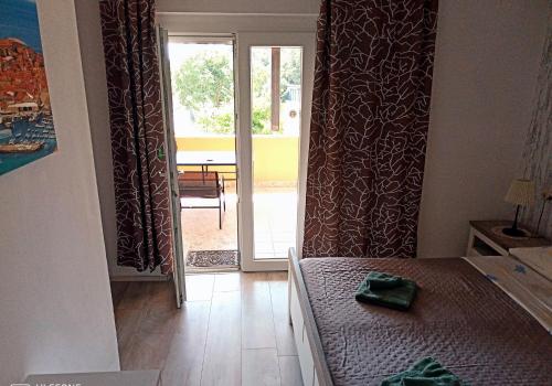 a bedroom with a bed and a sliding glass door at Villa Abelia in Medulin