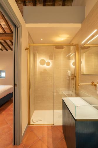 a shower with a glass door in a bathroom at Maison Ventiquattro in Talamello