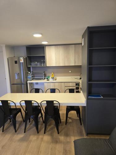 a kitchen with a table and chairs in a room at Baquedano in Coquimbo