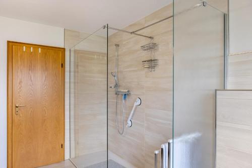 a shower with a glass door in a bathroom at Ferienwohnung Franni in Wabern