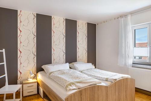 a bedroom with a bed and a window at Ferienwohnung Franni in Wabern