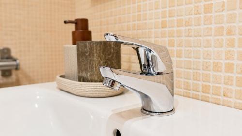 a bathroom sink with a faucet on a counter at Unique and special loft in Sant Joan de les Abadesses