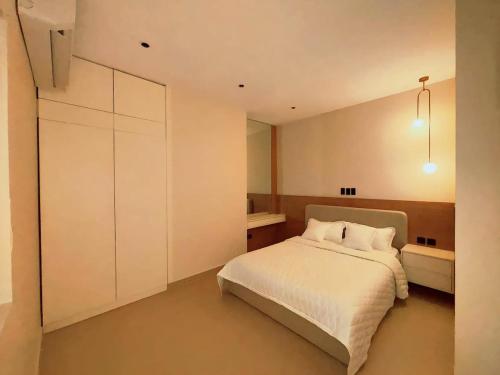 a bedroom with a bed and a white cabinet at شقق عبادي مميزه 1 in Dammam