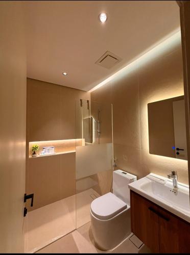 a bathroom with a toilet and a sink at شقق عبادي مميزه 1 in Dammam