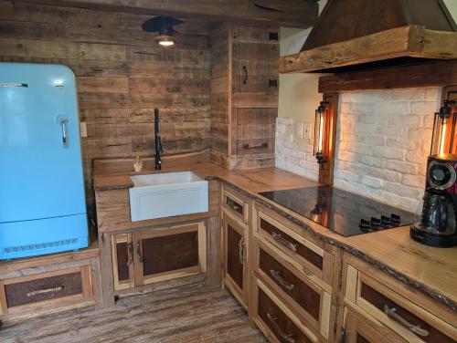 a kitchen with wooden cabinets and a sink at Lazy Bull Cottages in Bull Shoals