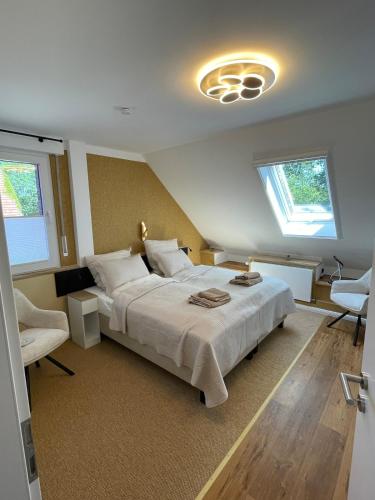 a bedroom with a large bed and two windows at Charmantes Apartment mit gemütlichem Flair außerhalb gelegen in Bad Essen