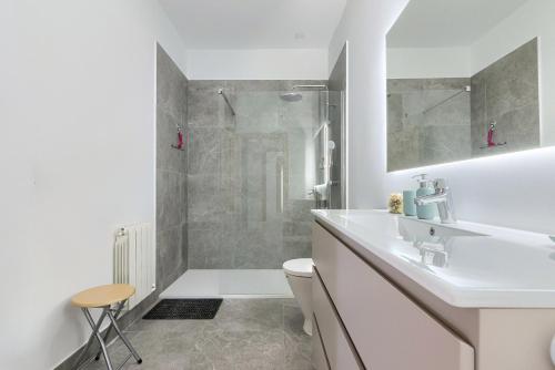 a white bathroom with a sink and a shower at Casa Eleizpe by Next Stop Bilbao in Ergoyen