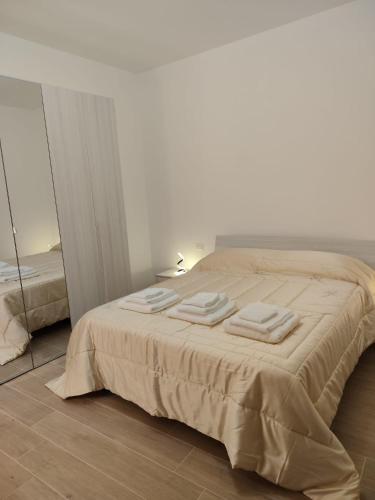 a bedroom with a bed with three towels on it at Casa Aurora & Santiago in Trapani