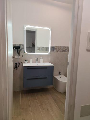 a bathroom with a sink and a mirror and a tub at Casa Aurora & Santiago in Trapani