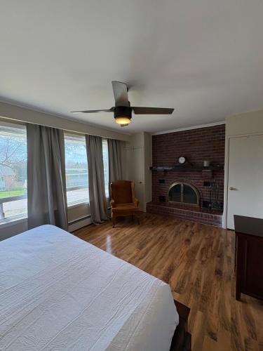 a bedroom with a bed and a brick fireplace at Spacious Cottage Style Home in Toronto