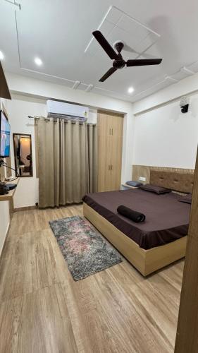 a bedroom with a bed and a ceiling fan at Healer home in Rishīkesh