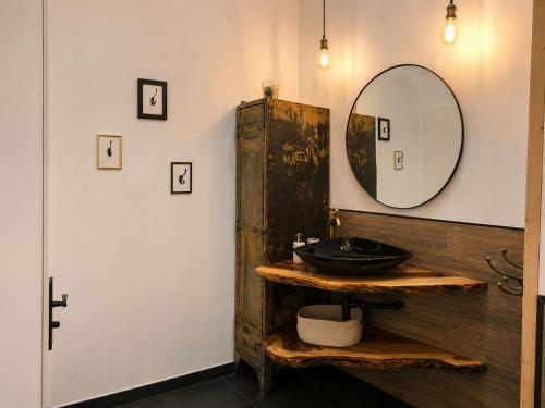 a bathroom with a sink and a mirror at L inarretable studio independant in Cézac