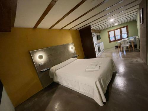 a bedroom with a large bed in a room at Casa O'Tinte in Alquézar