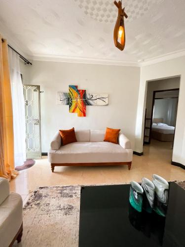 a living room with a white couch in a room at Happy homes stay in Namugongo