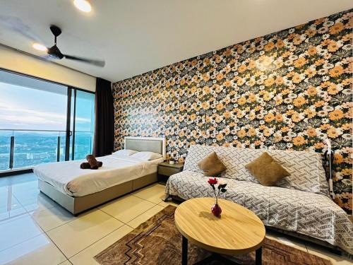 a bedroom with a bed and a couch and a table at Comfort Zone Premium Guesthouse @ Evo Bangi in Bangi