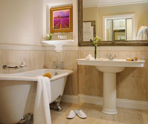 a bathroom with a tub and a sink and a bath tub at Great Southern Killarney in Killarney